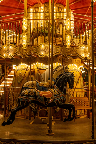 Ornate carousel horse illuminated by warm lights at night