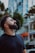 Man with beard looking up at buildings