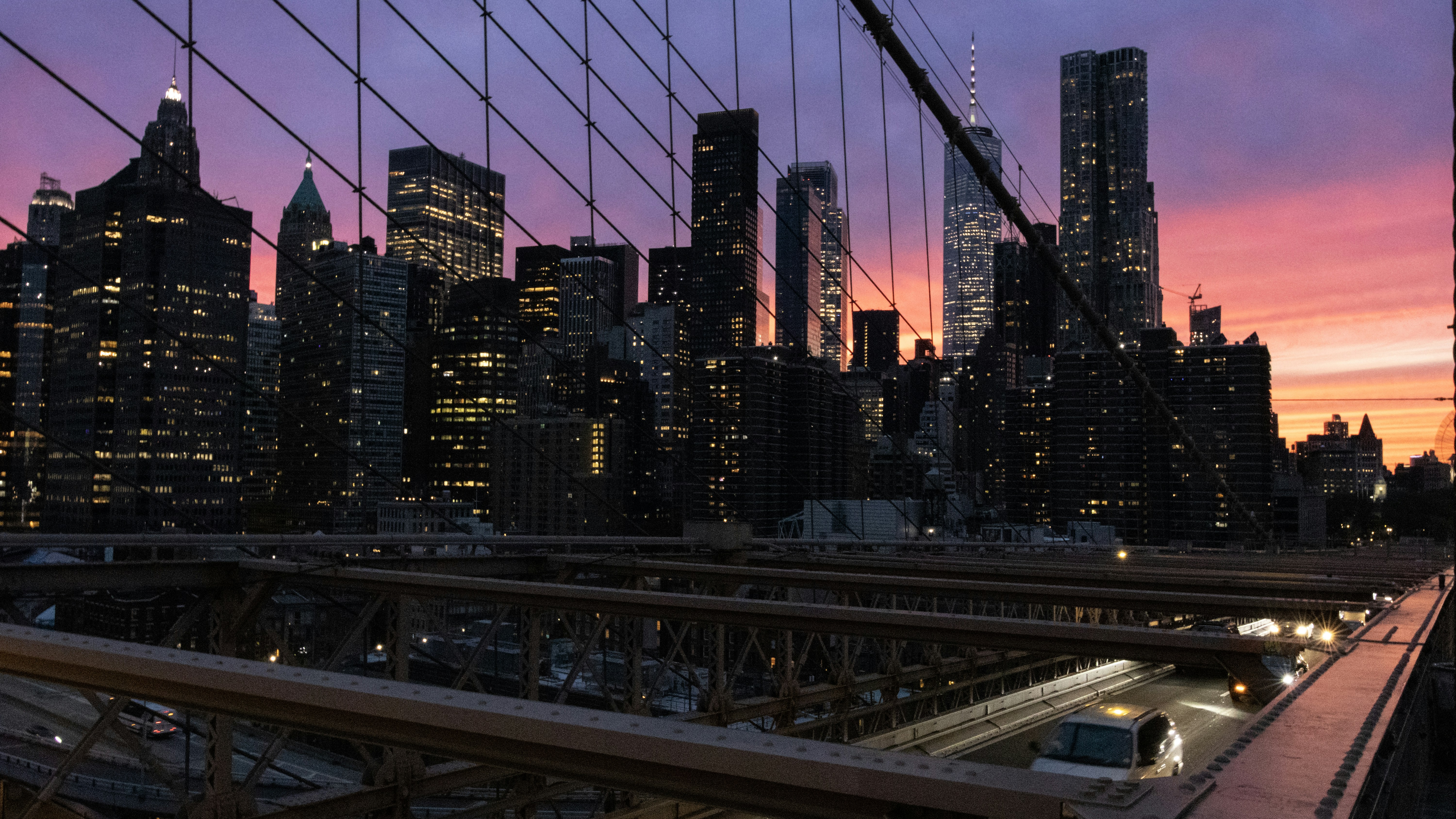 City skyline at dusk with bridge in foreground