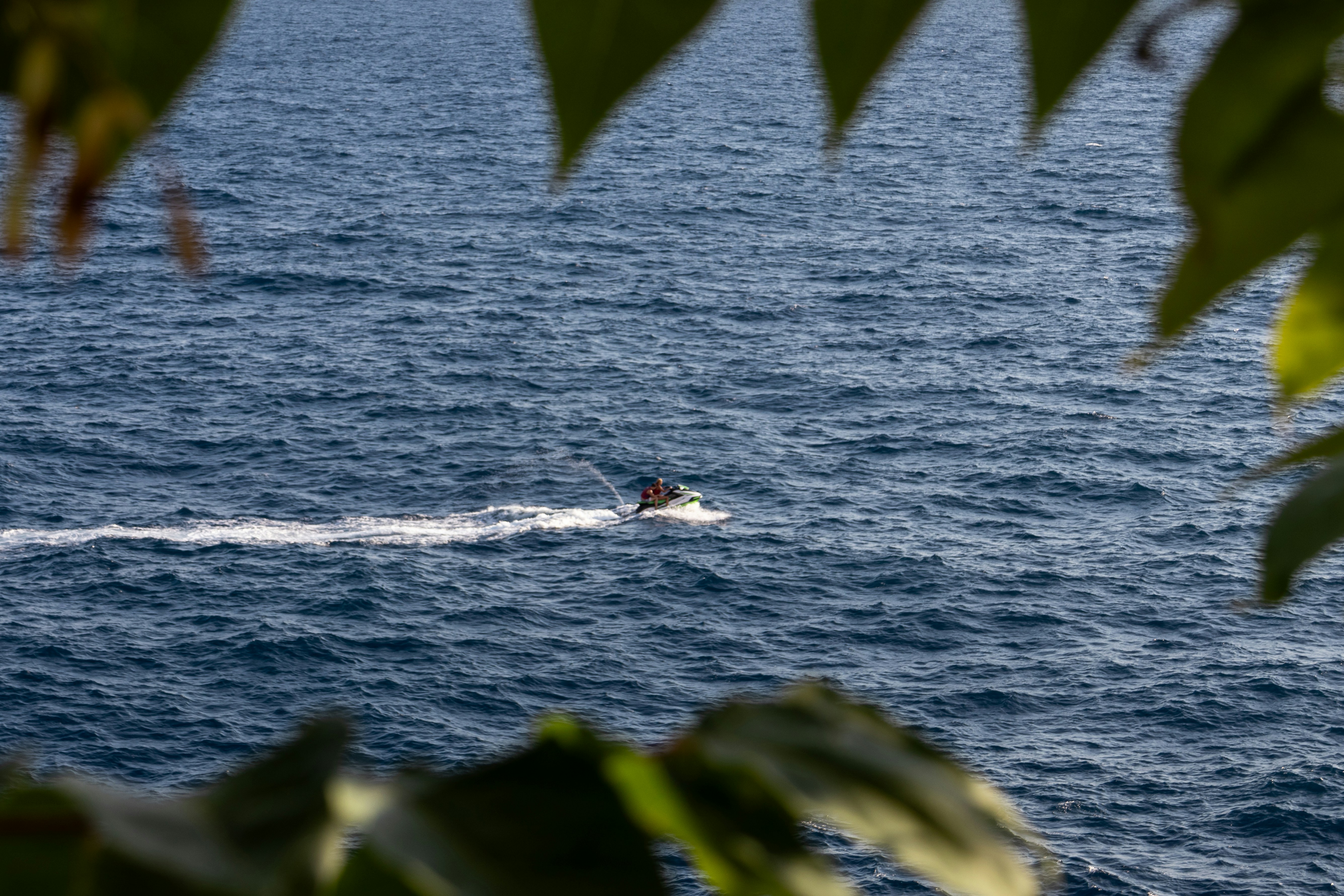 Person riding a jet ski on the ocean.