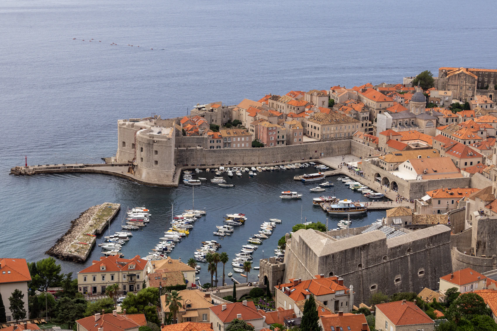 Dubrovnik's old harbour, fortifications and terracotta roofs seen from above