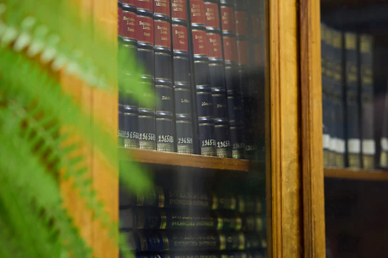 Bookshelves filled with old books in a library.