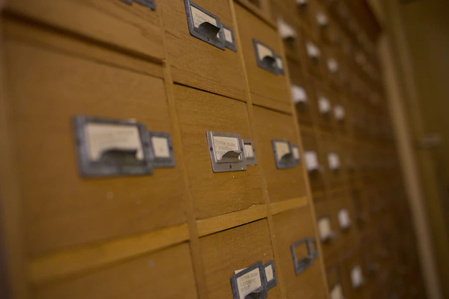 Wooden library card catalogue drawers, labelled and closed