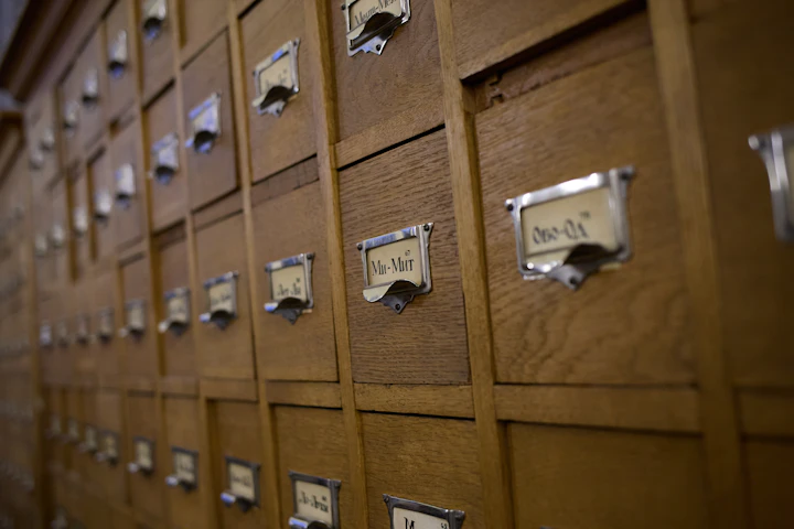 Wooden library card catalogue drawers, a picture of how a search index files pages after a technical SEO checklist clears them