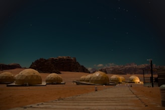 Desert encampment with dome tents under starry night sky