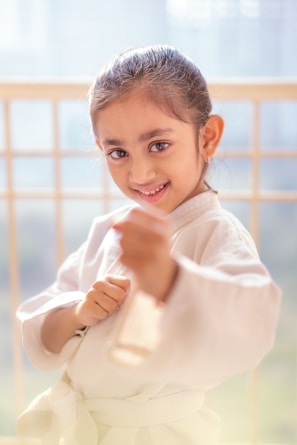 Young girl in karate uniform with a determined expression