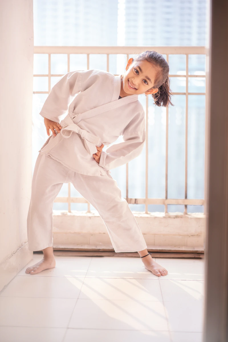 Young girl training in a martial arts uniform