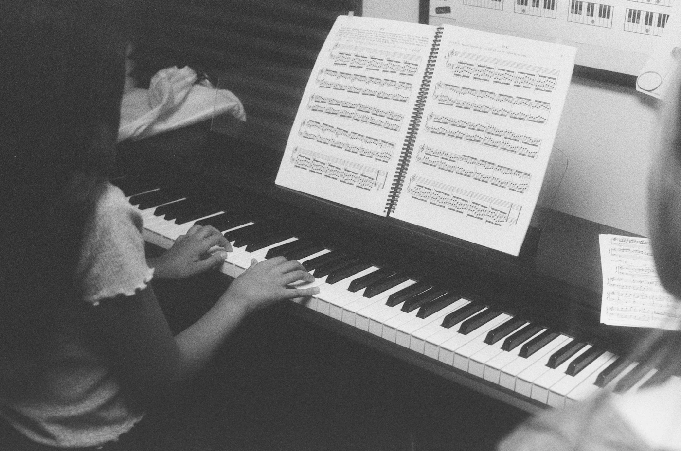 Children learning to play piano together