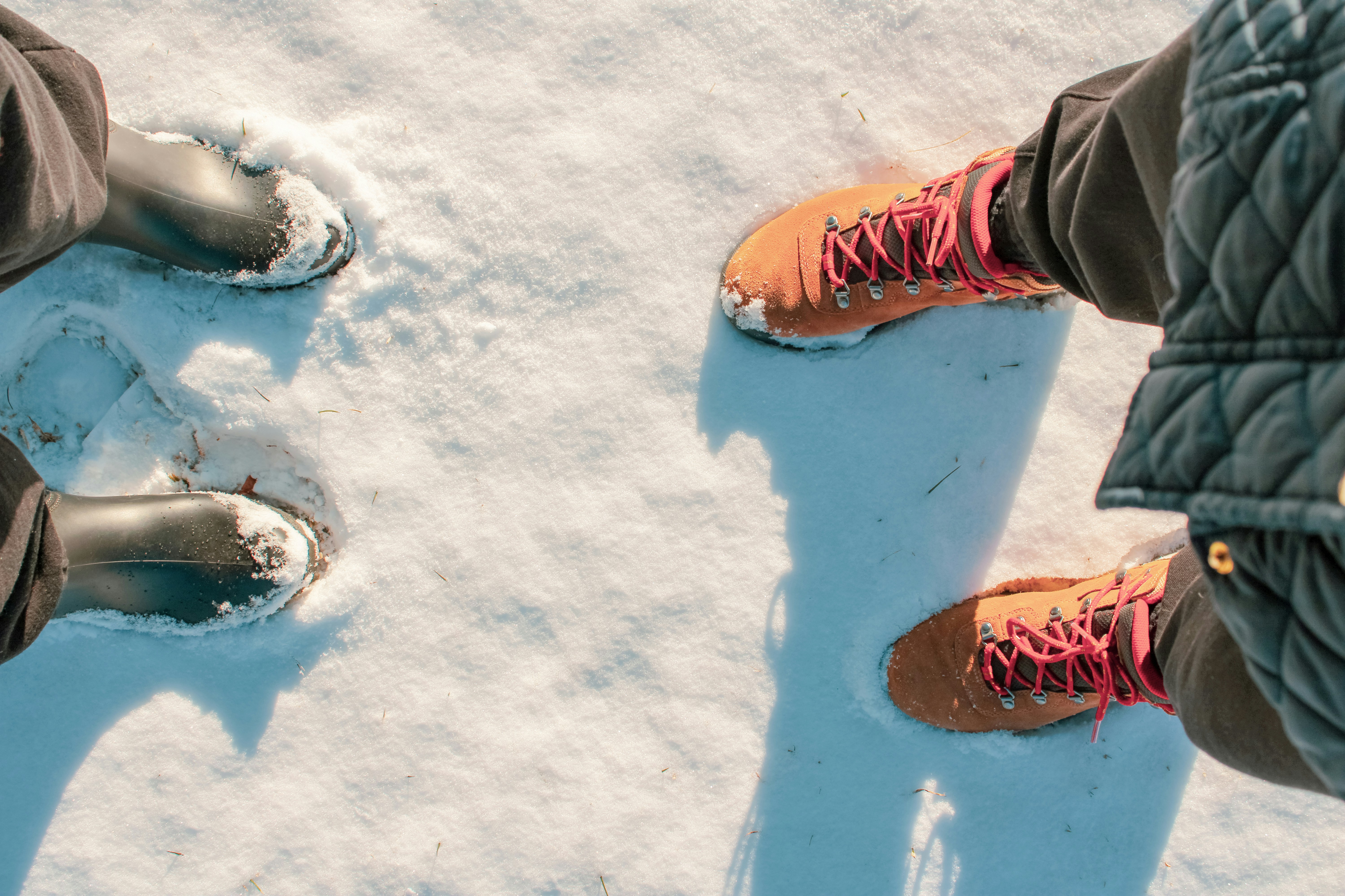 Zwei Paar Stiefel stehen im Schnee