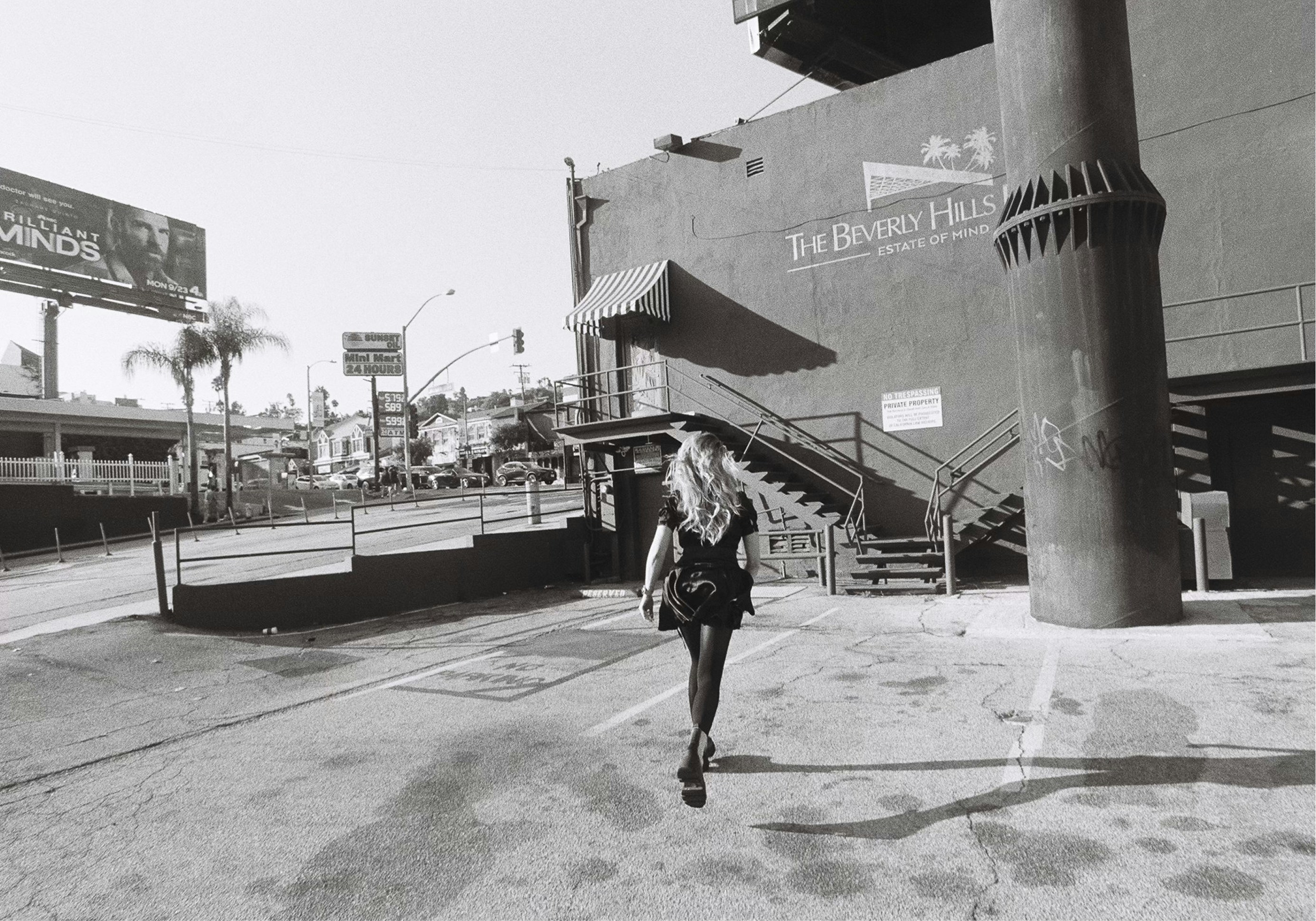 Woman walking away from camera on sunny day