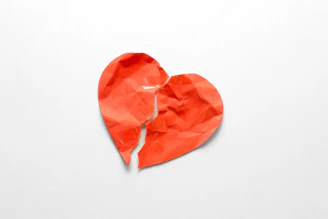 A torn red heart on a white background
