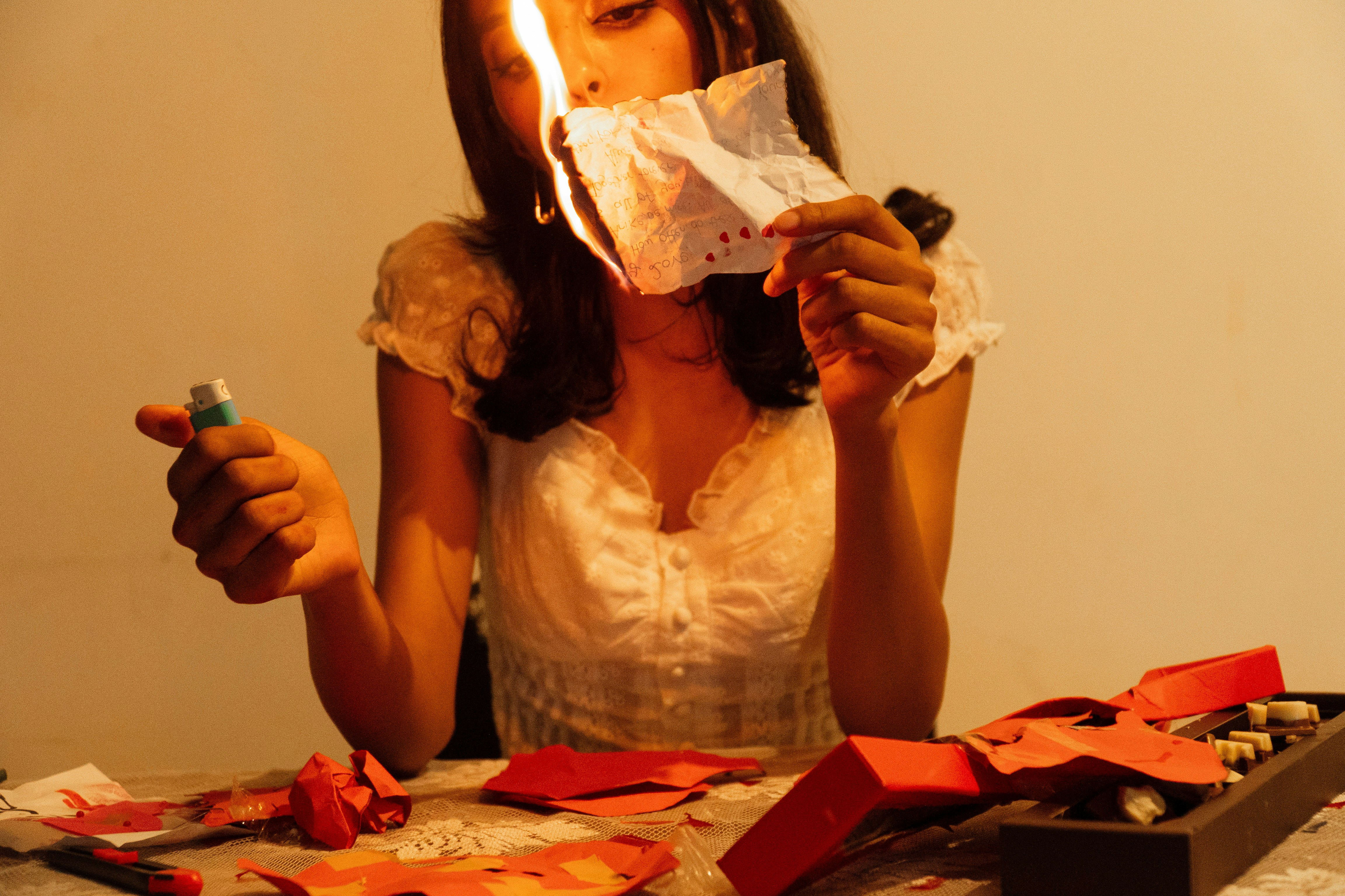 Woman burning paper with a lighter