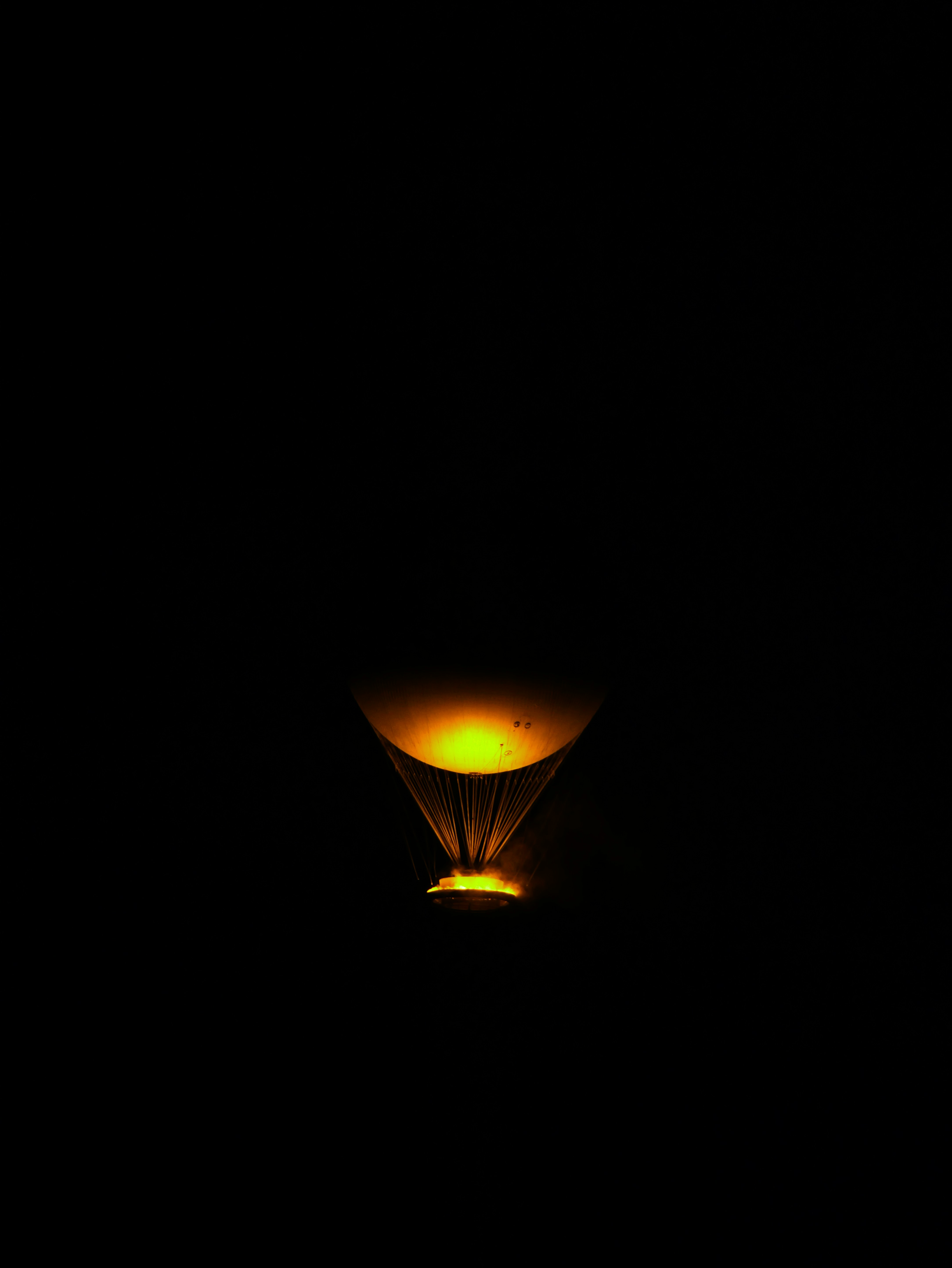 A cocktail glass with glowing yellow liquid