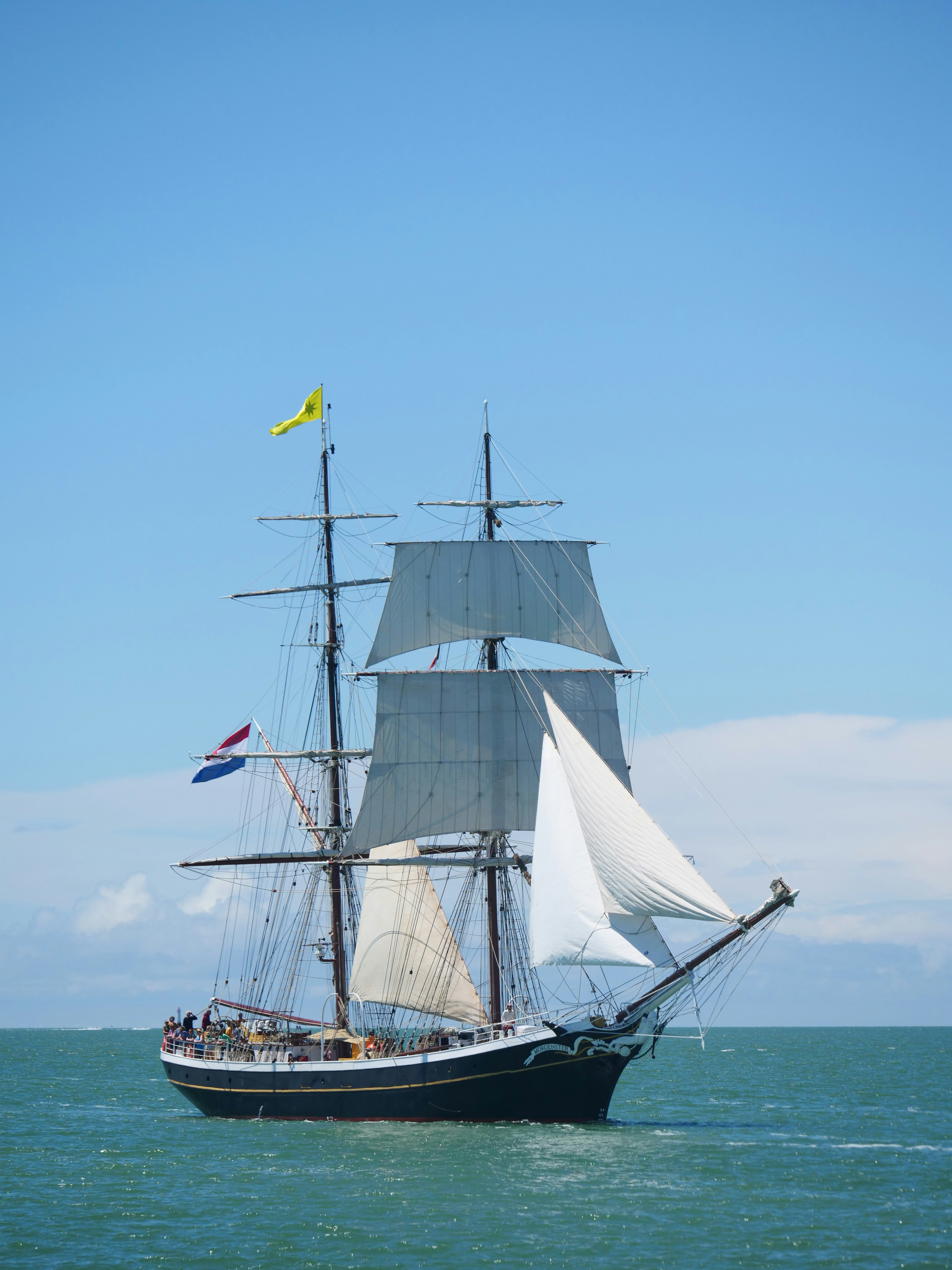 A tall ship with full sails on the ocean