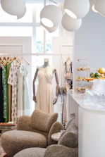 A boutique clothing store interior with dresses and accessories.