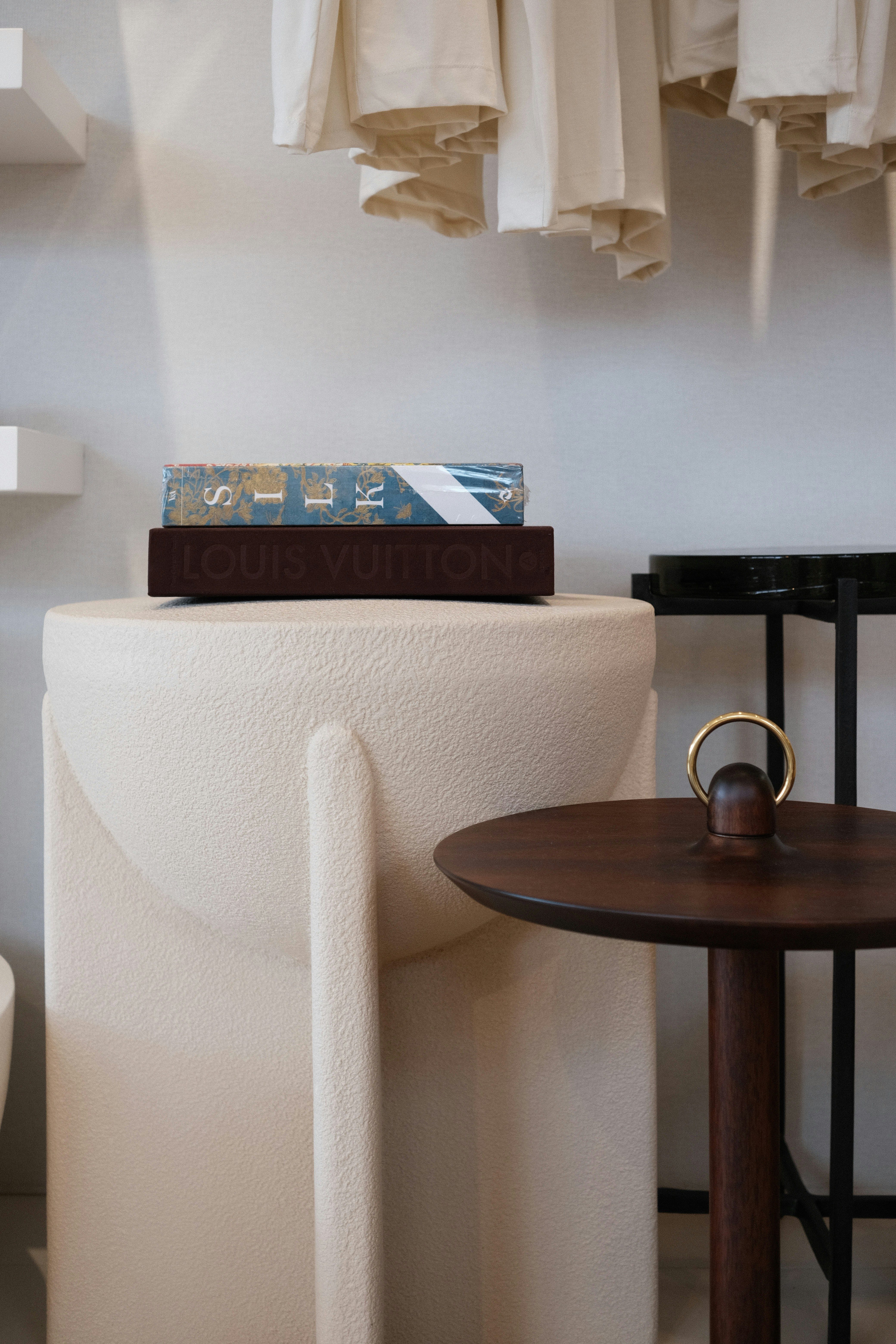 A book with "louis vuitton" on a pedestal.