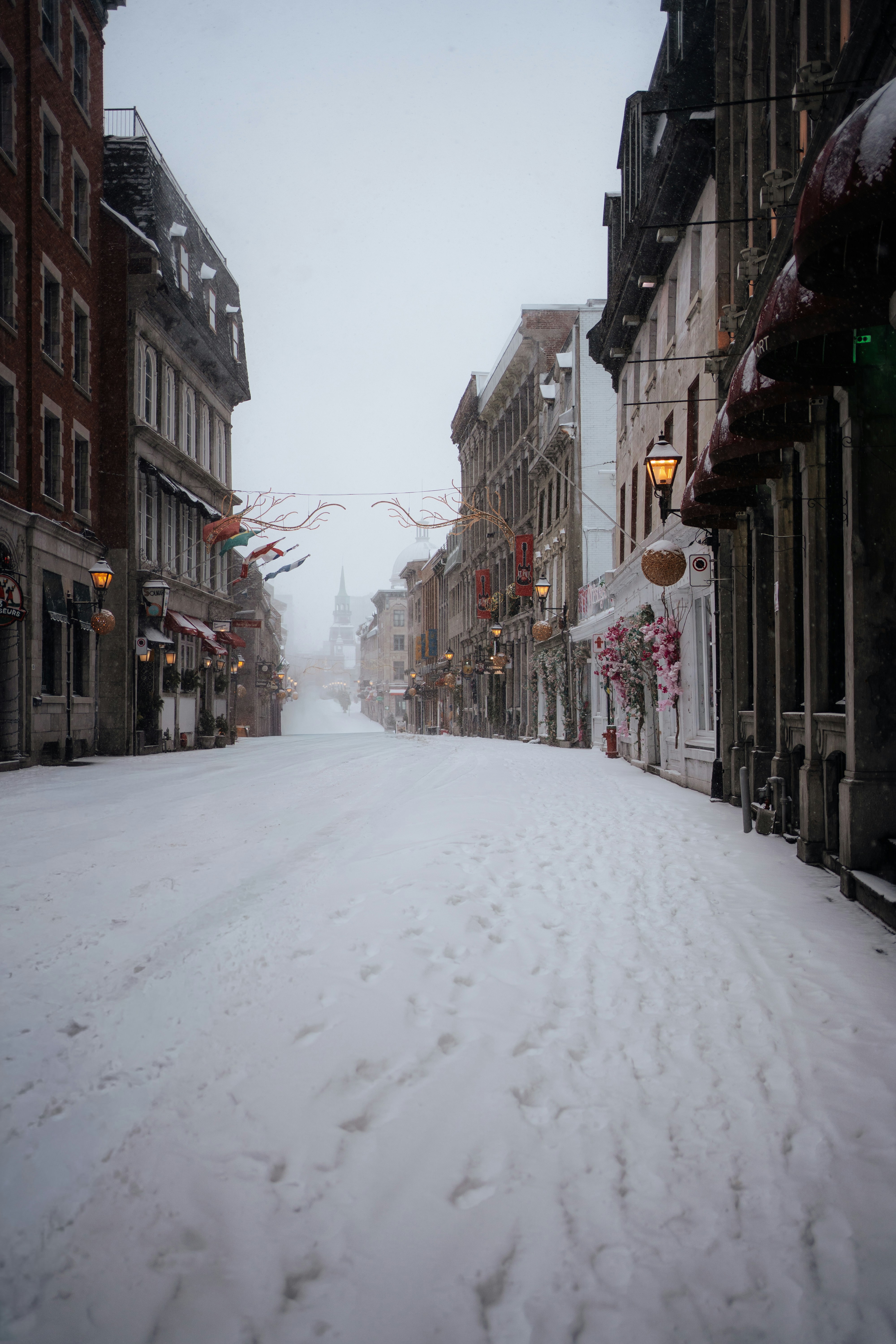 Snow-covered street lined with historic buildings