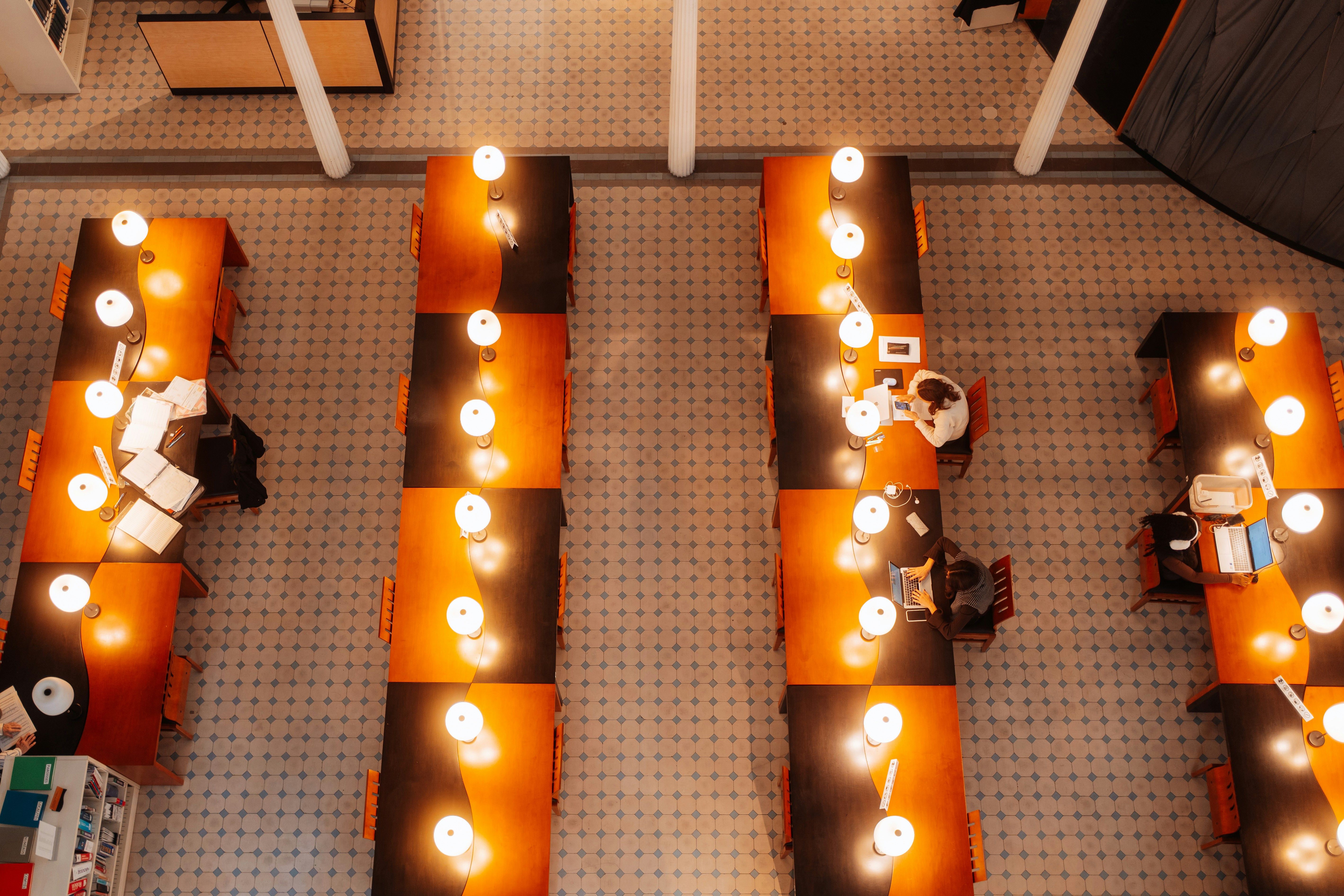 Overhead view of people working at checkered desks