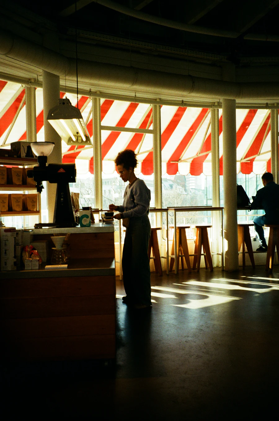 Barista working behind the counter in a sunlit café
