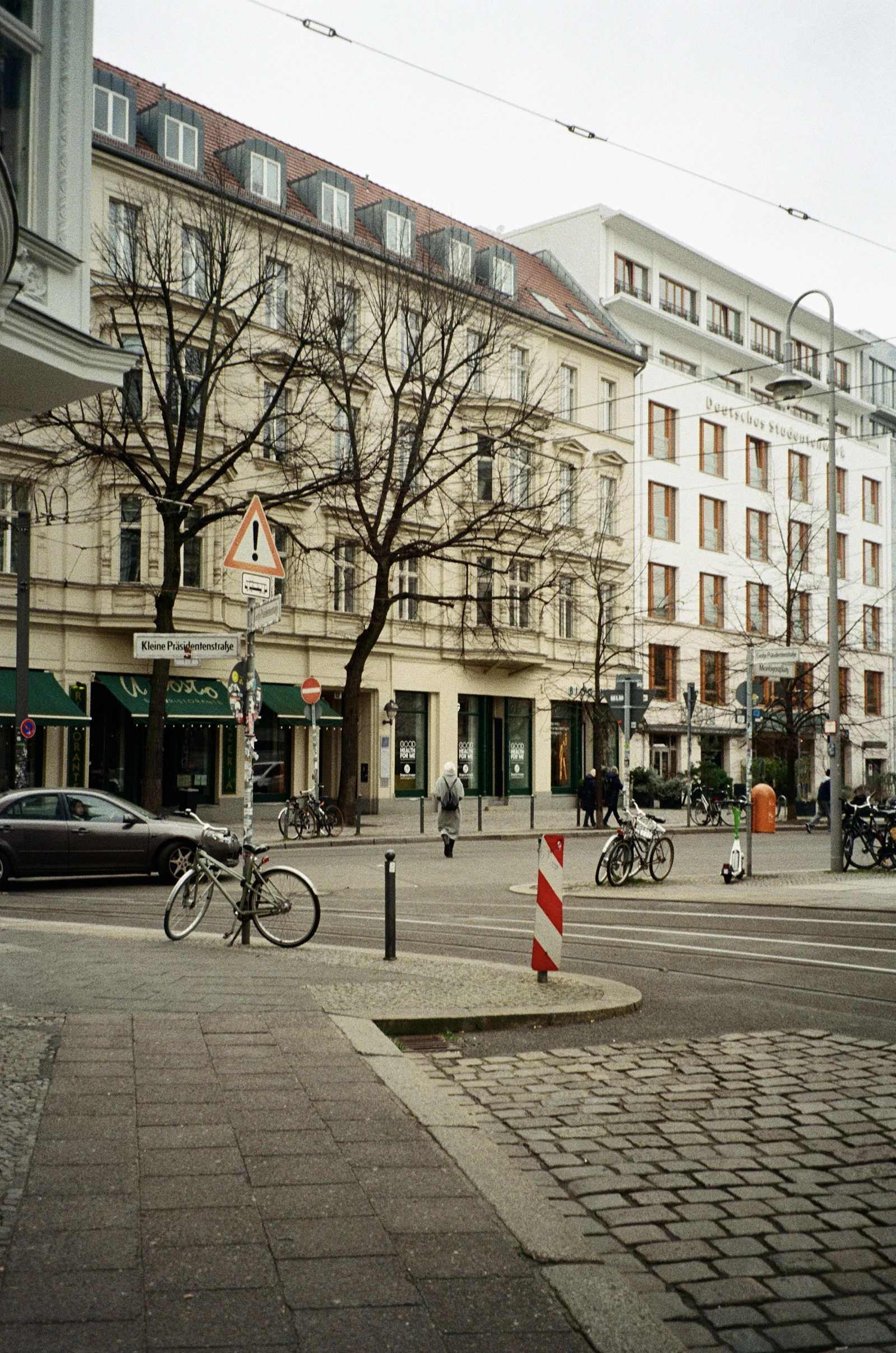 Parked cars and bicycles share a Berlin street