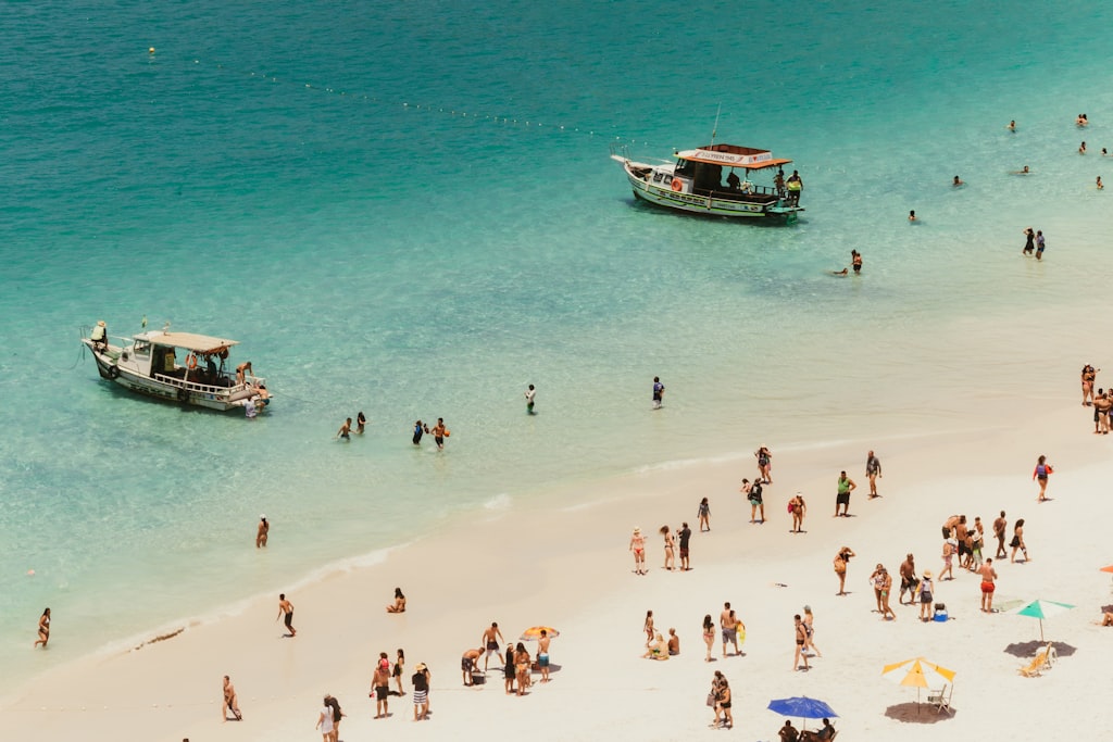Tropical beach vacation scene with people enjoying a sunny day by the ocean
