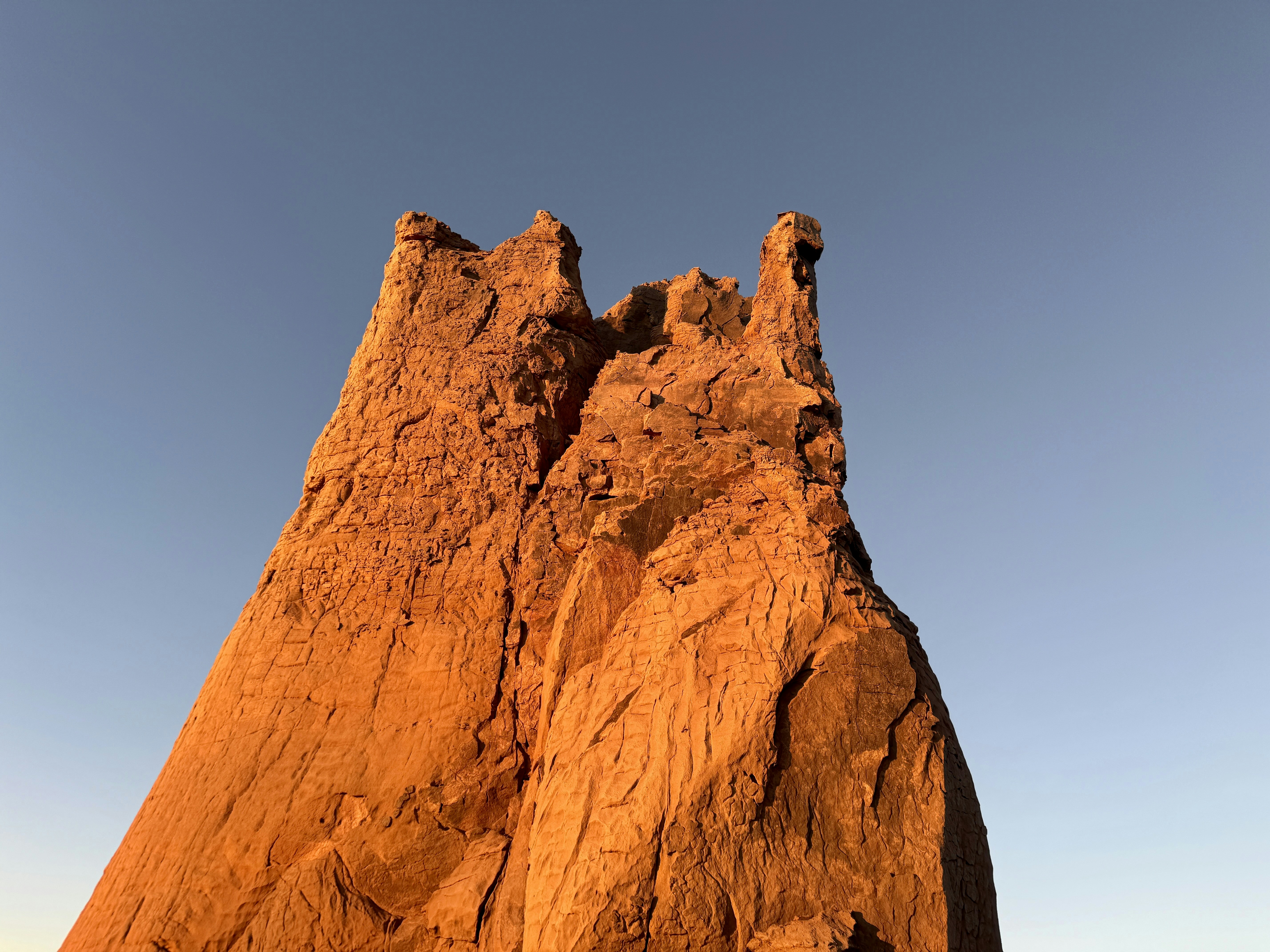 Orange rock formation against a clear blue sky