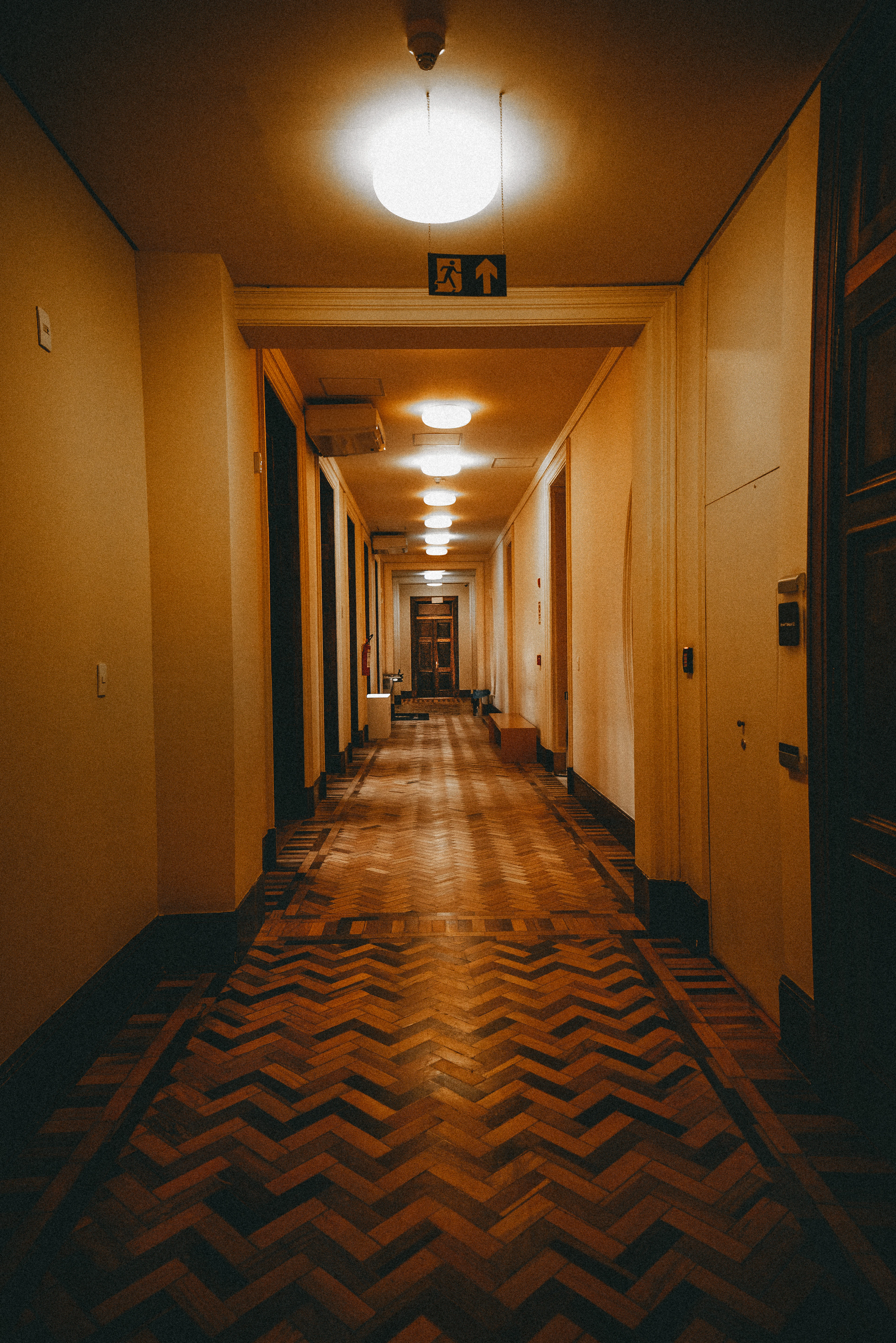 Hallway with a patterned wooden floor