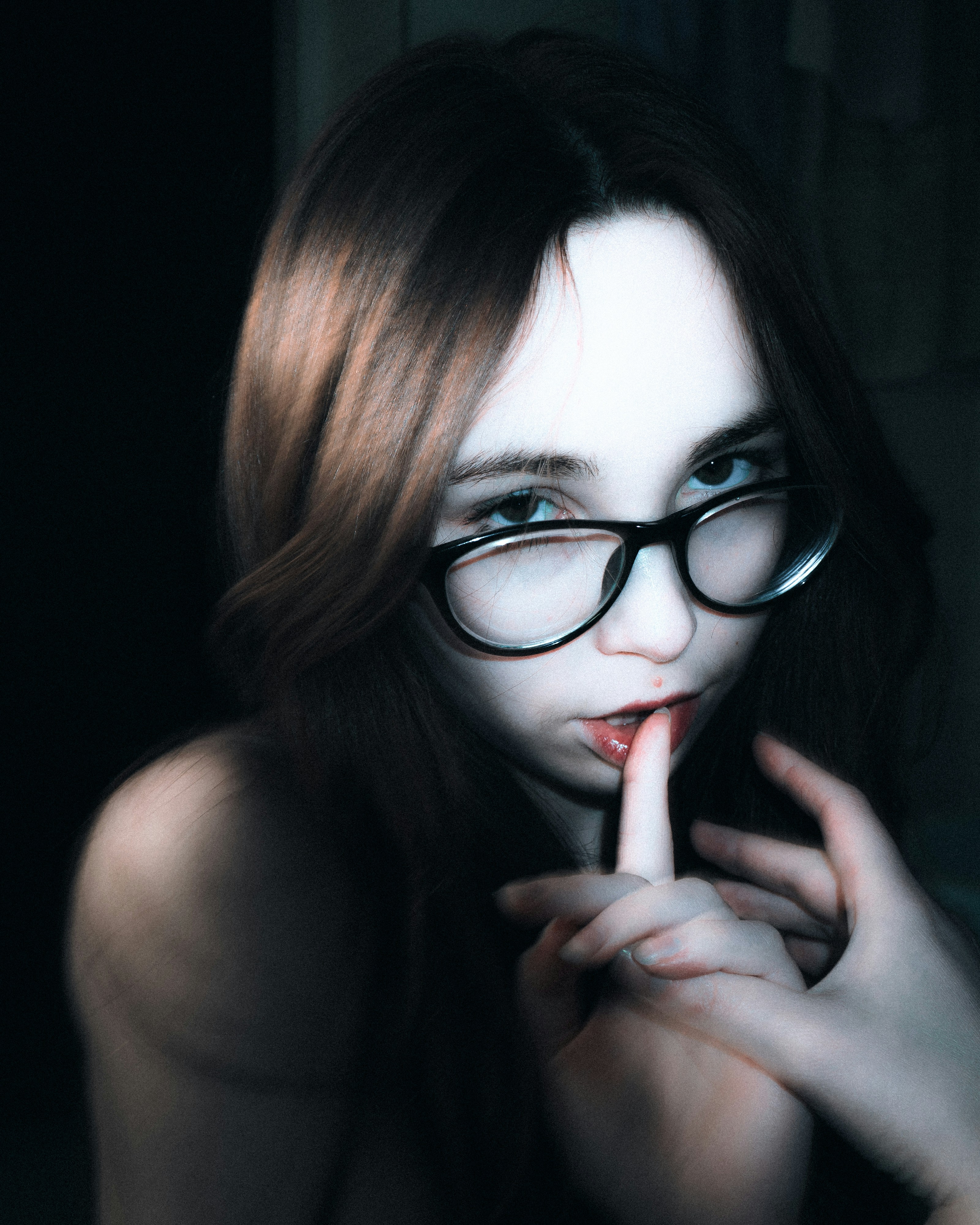 Young woman with glasses looking at camera