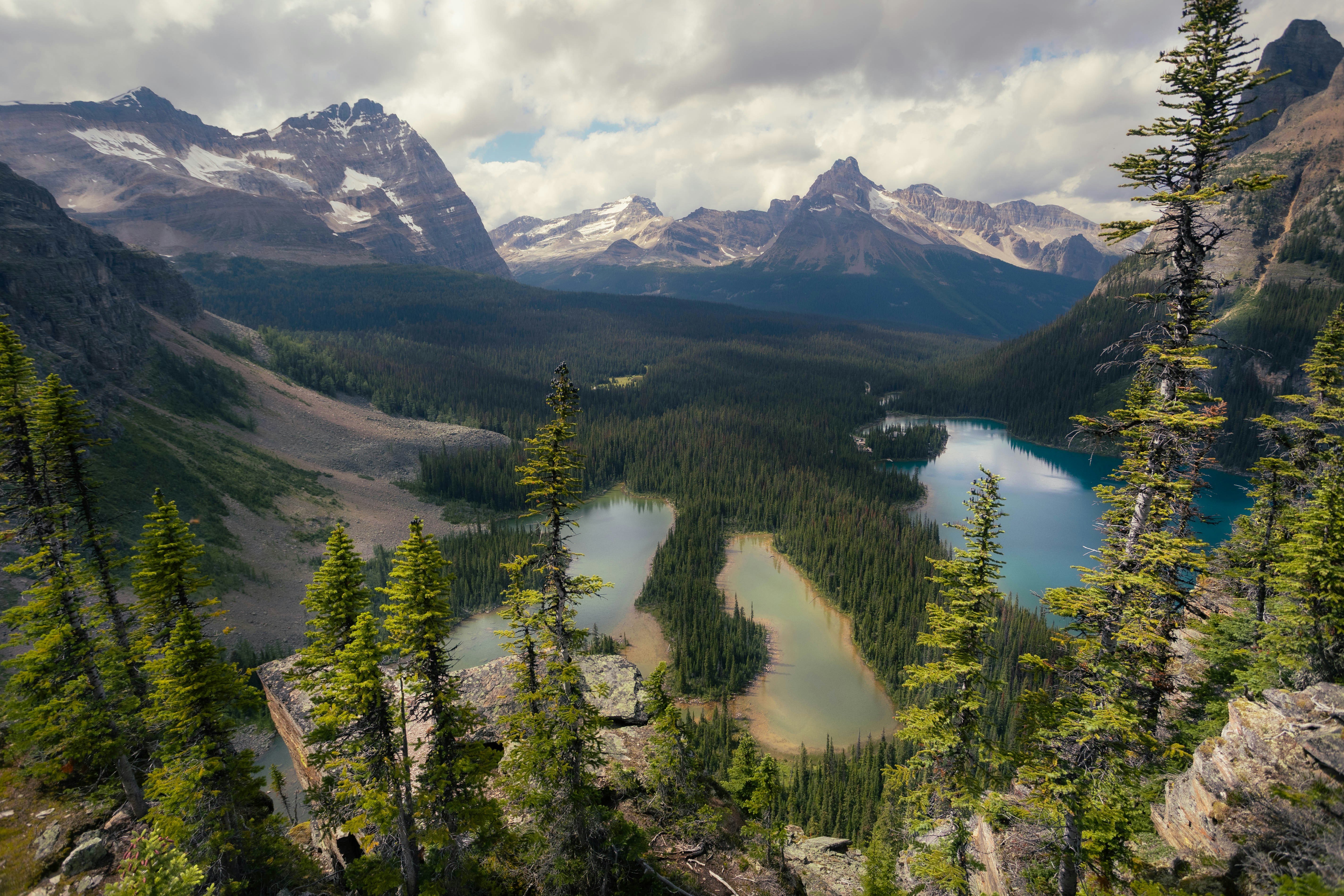 Majestic mountain range with pristine lakes and evergreen forest.