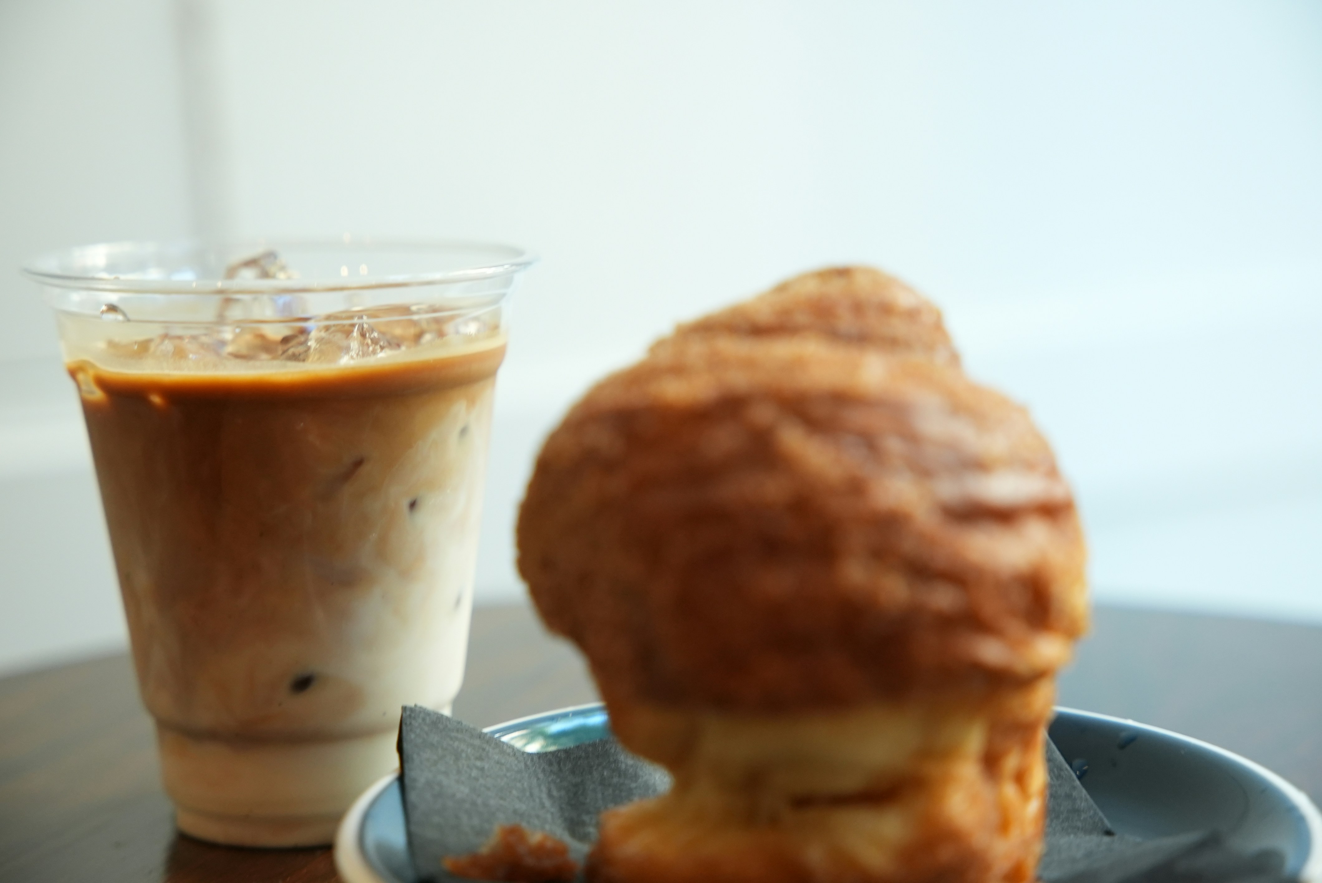 Iced coffee beside a pastry