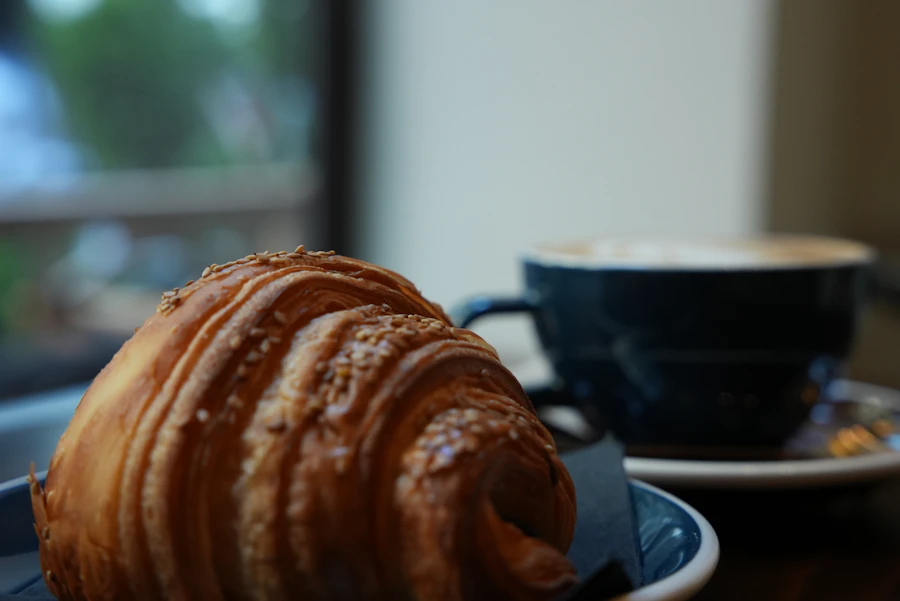Coffee and croissant representing nearby breakfast and coffee options