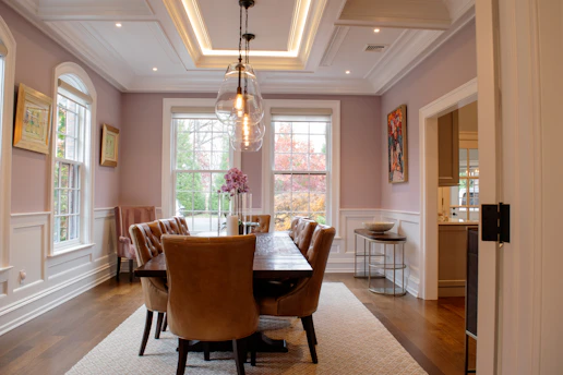 Elegant dining room with plush chairs and modern chandelier