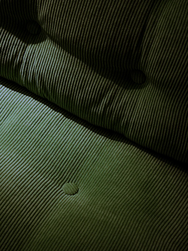 Close-up of tufted green corduroy upholstery