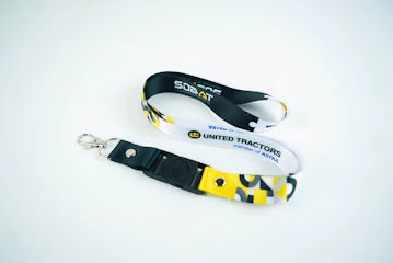 Two lanyards with united tractors logo on white background