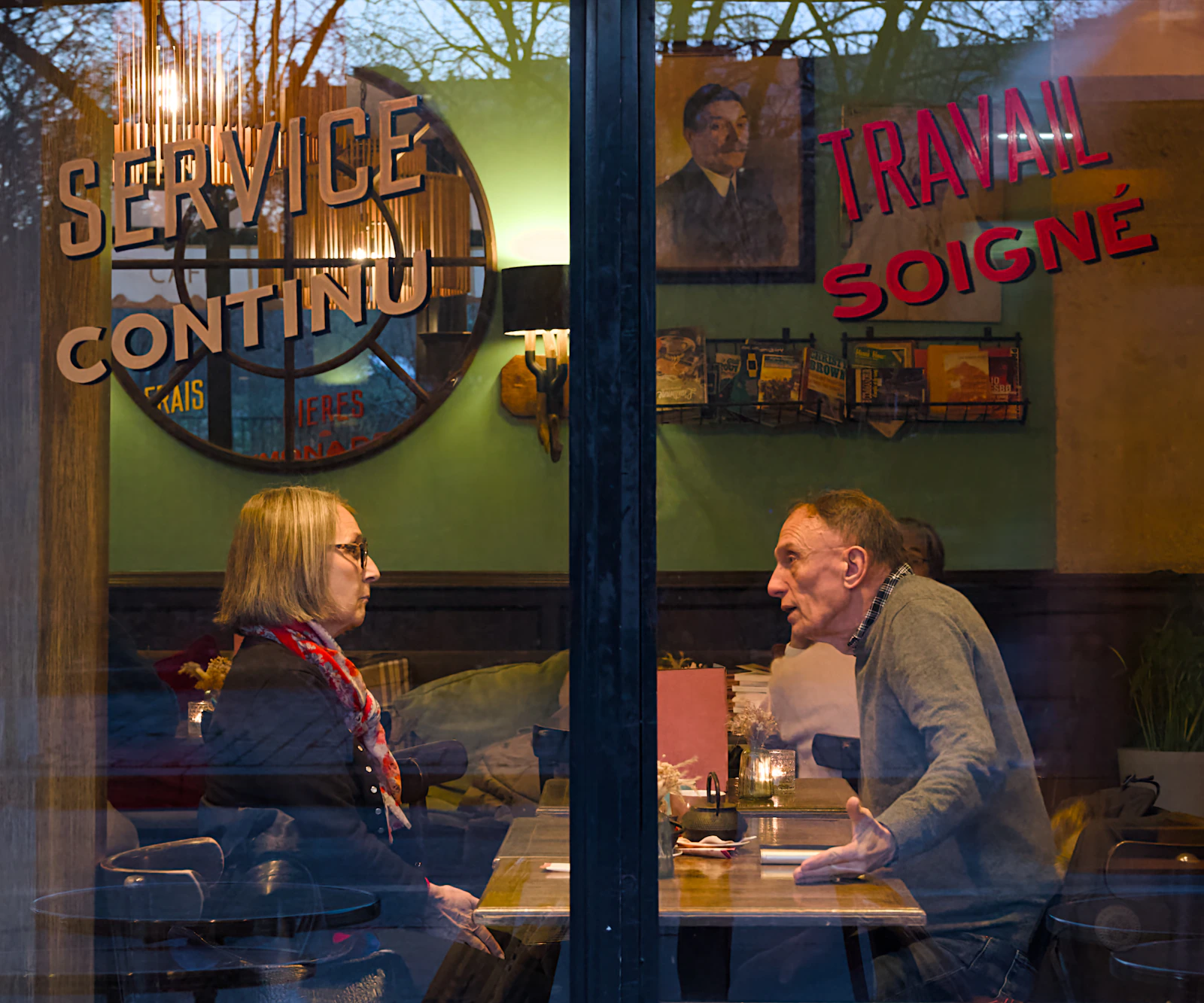 Two people talking at a cafe on an early date after a long relationship