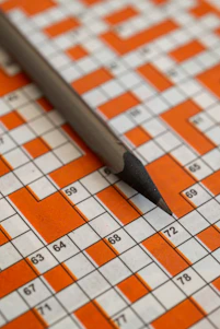 A pencil rests on a crossword puzzle.
