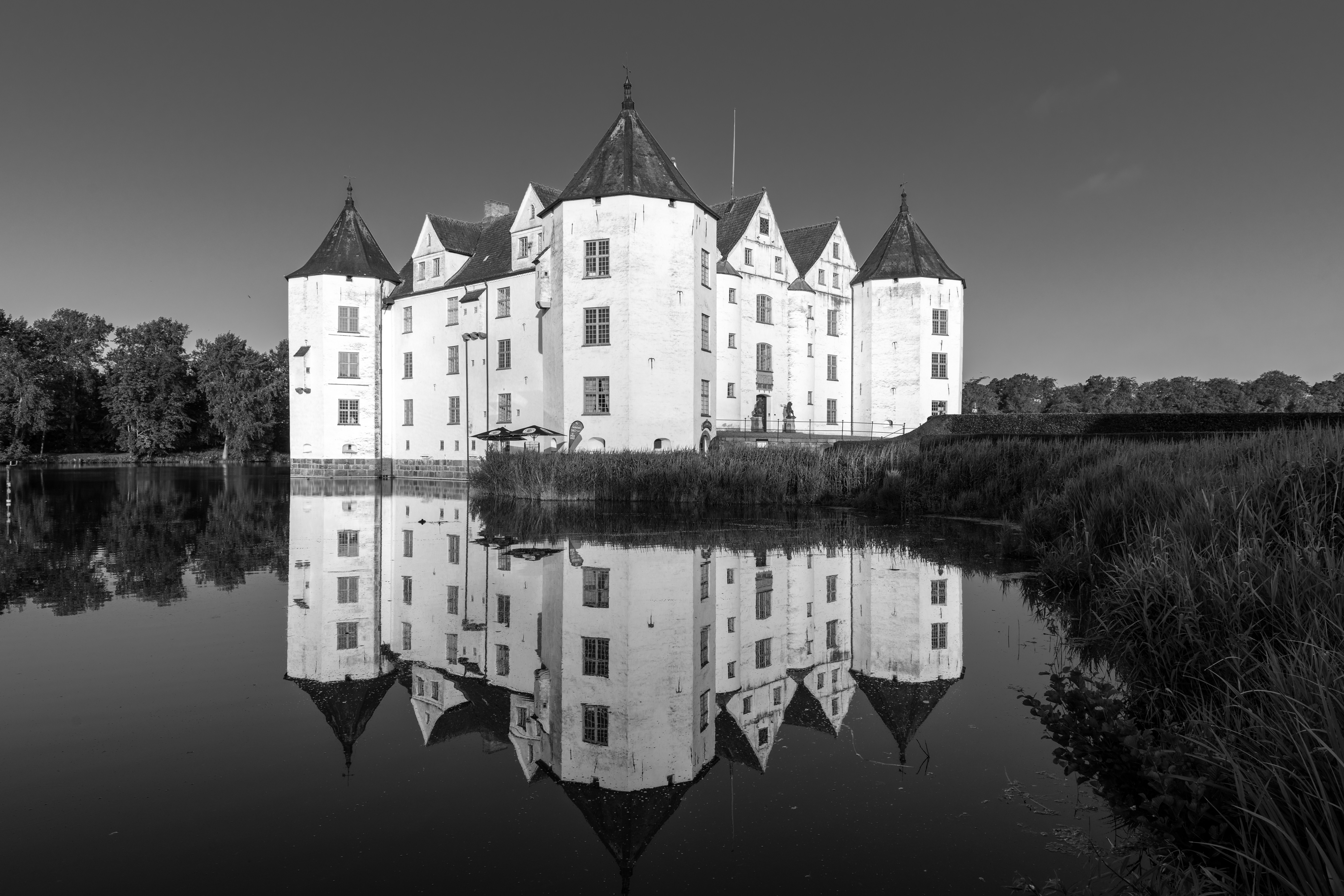 A white castle reflected in calm water