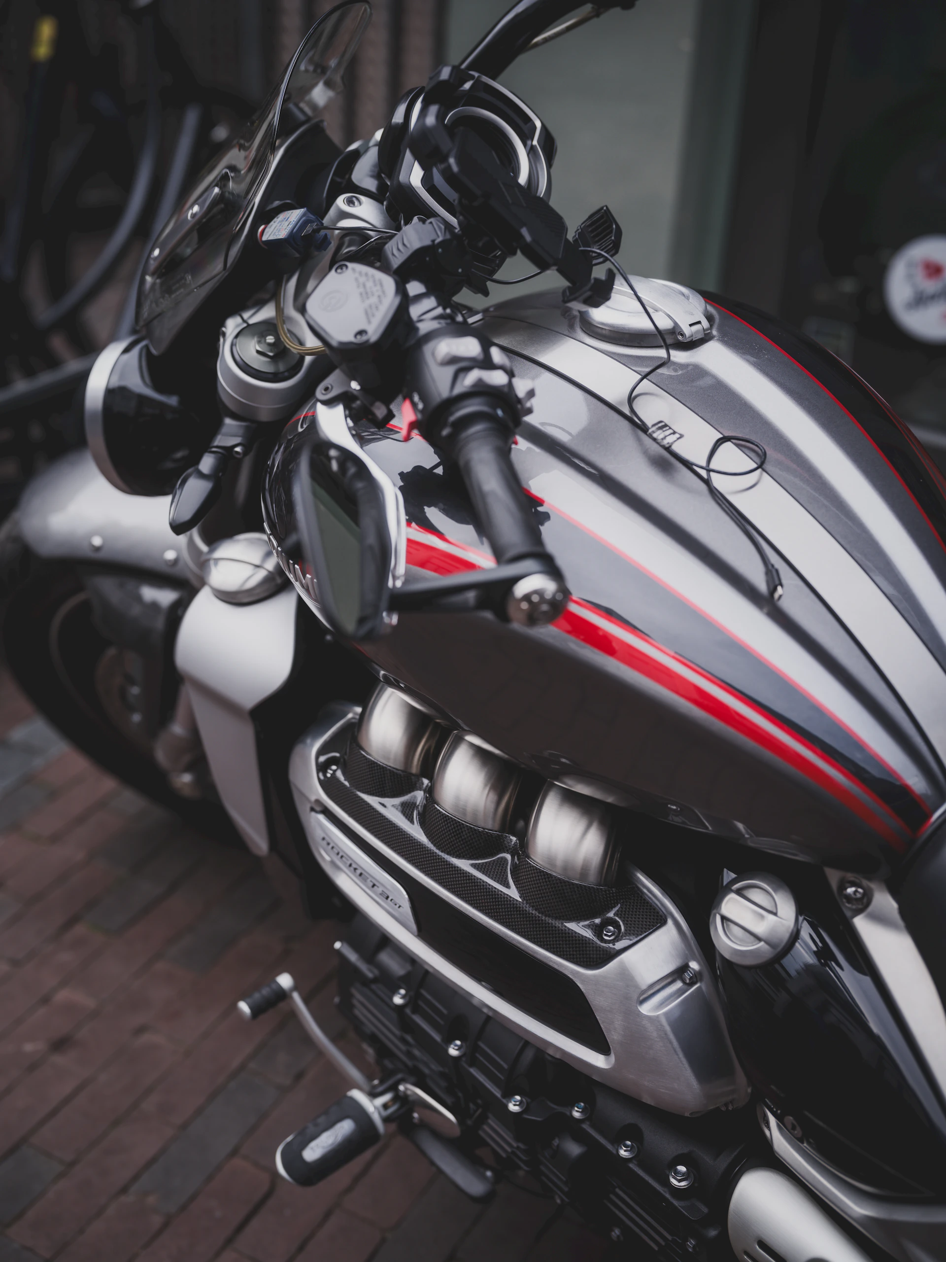 Close-up of a sleek, silver motorcycle with red accents