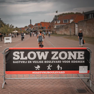 Slow zone banner with people and buildings in the background