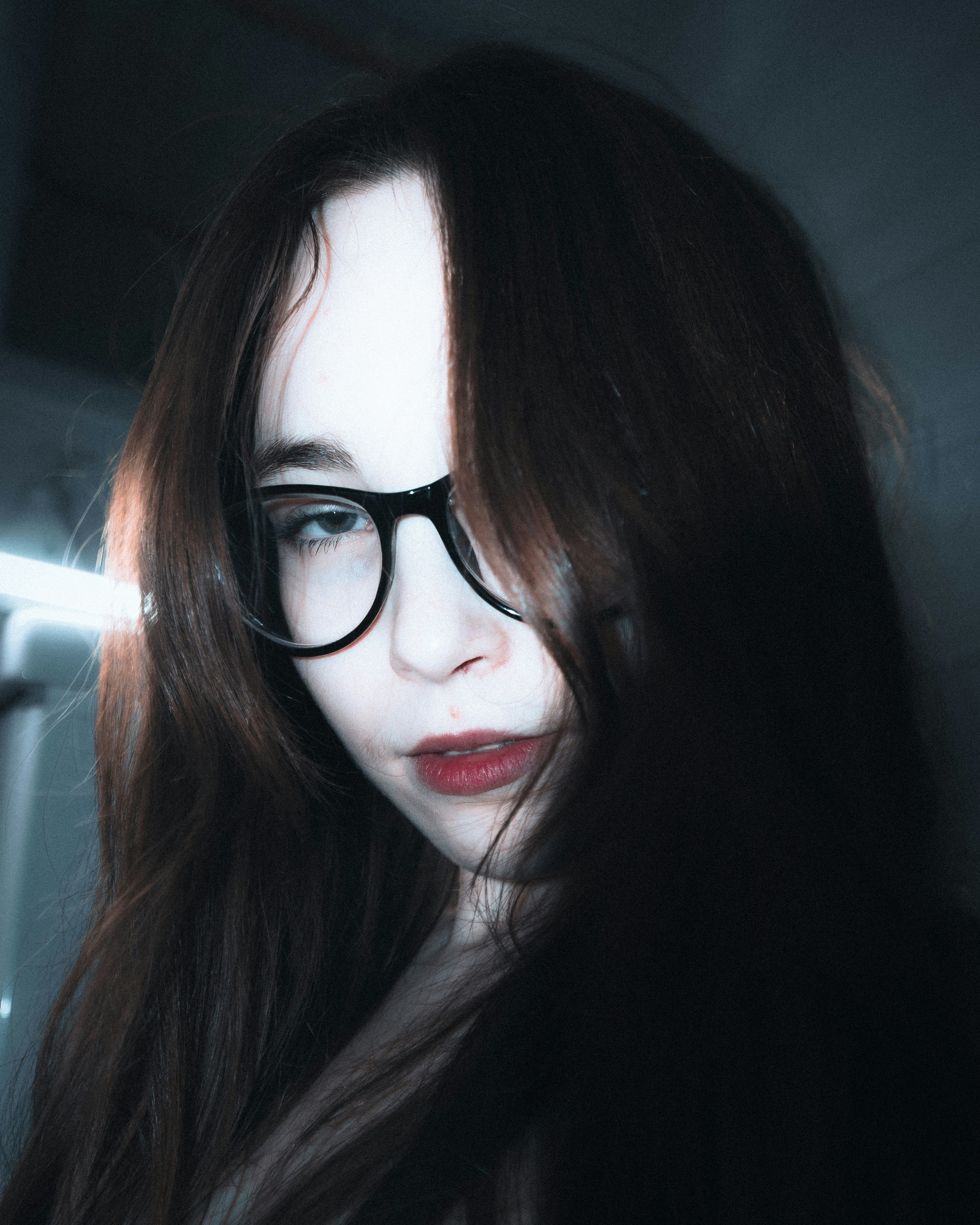 Woman with glasses and dark hair looking at camera.