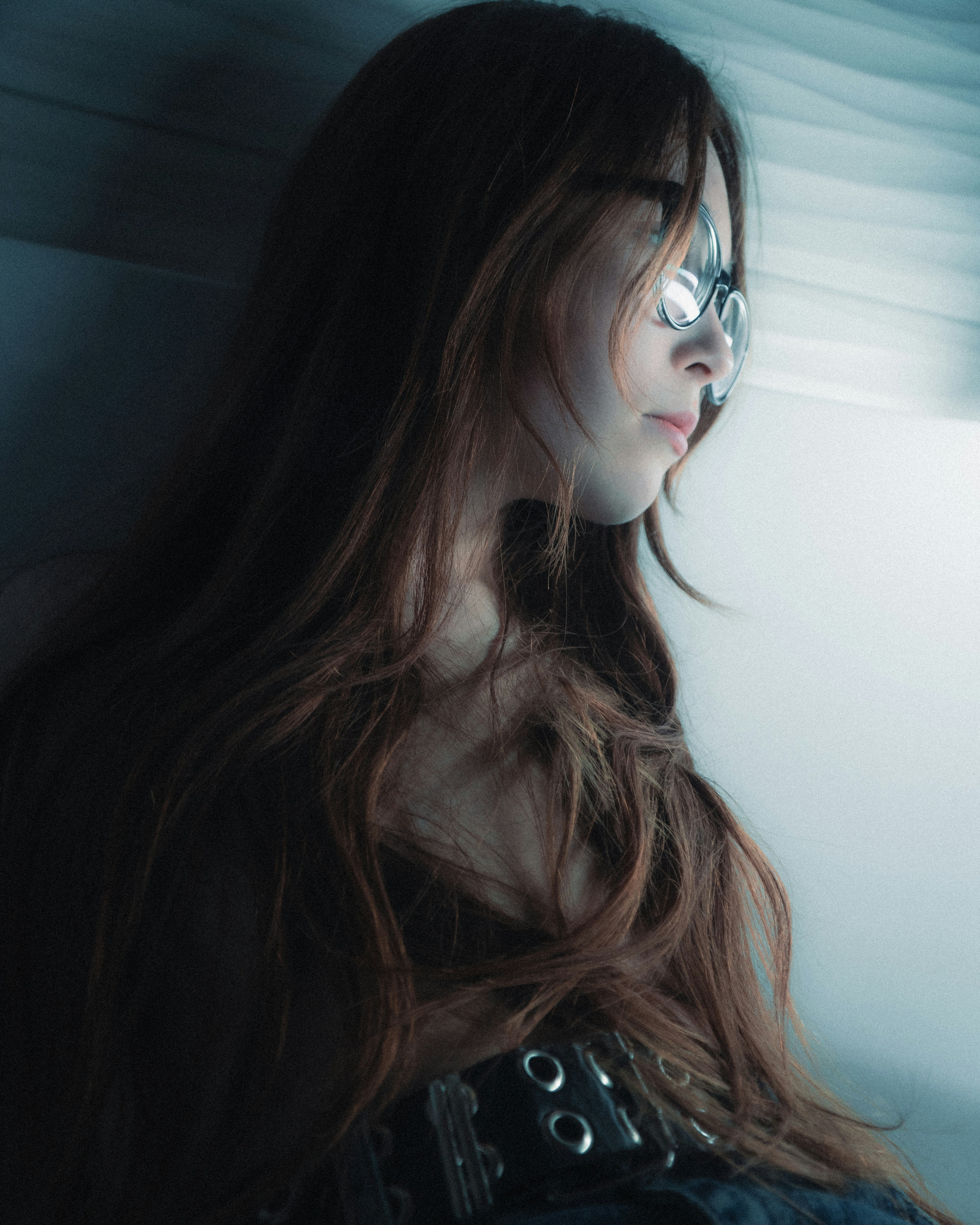 Young woman with long brown hair wearing glasses