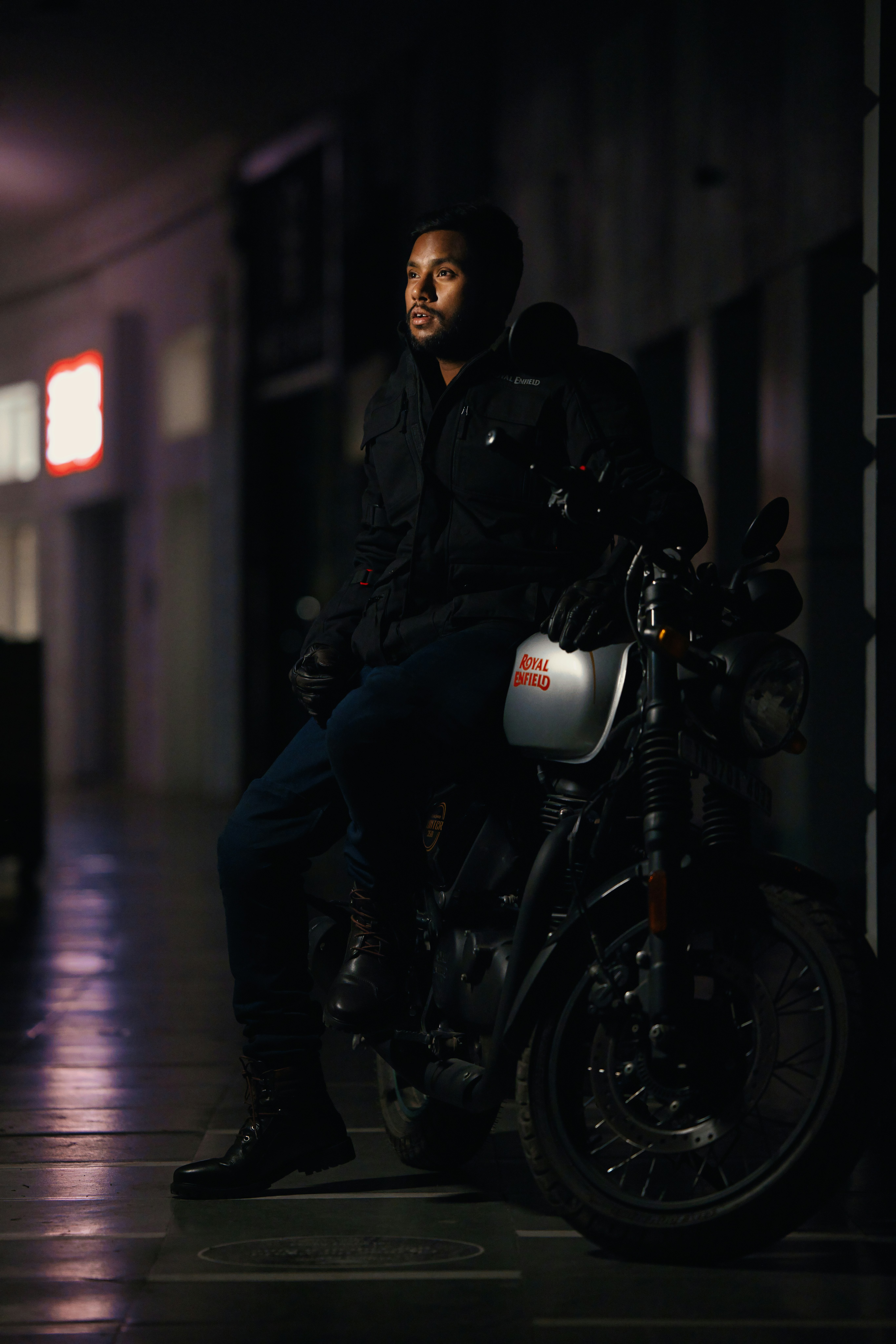 Man in black jacket sitting on motorcycle