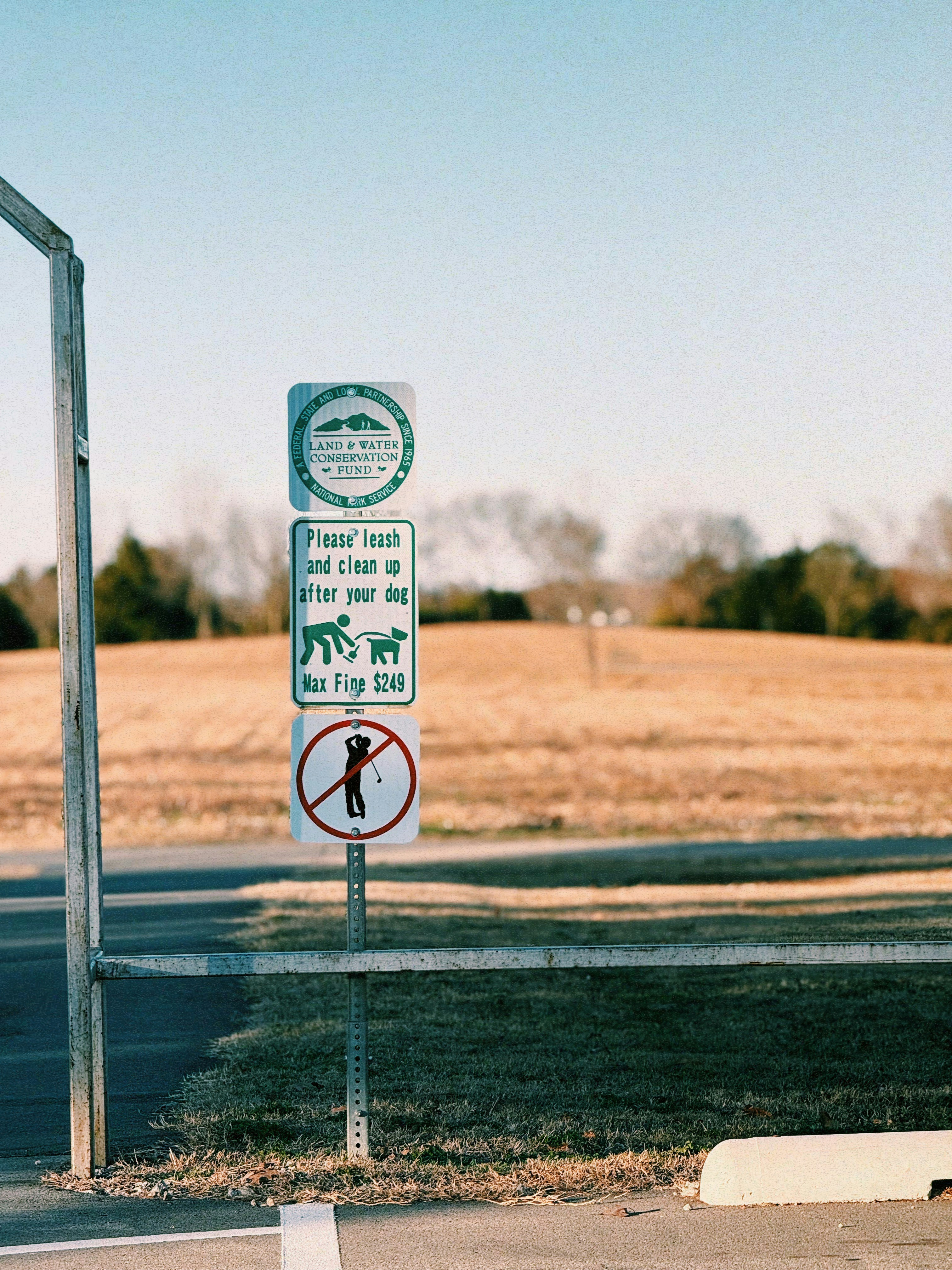 Park signs indicating rules for dog owners