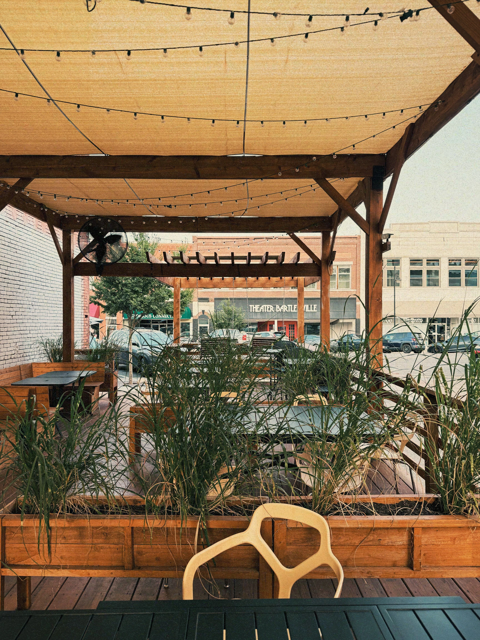 Outdoor patio seating with string lights and plants.