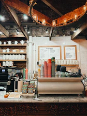 Coffee shop counter with colorful cups and bags