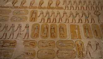 Ancient egyptian hieroglyphs and figures on a tomb wall