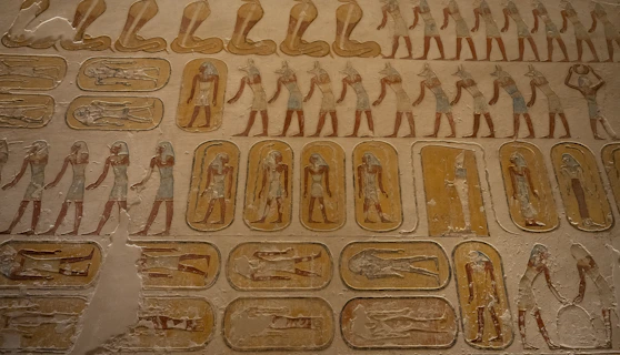 Ancient egyptian hieroglyphs and figures on a tomb wall
