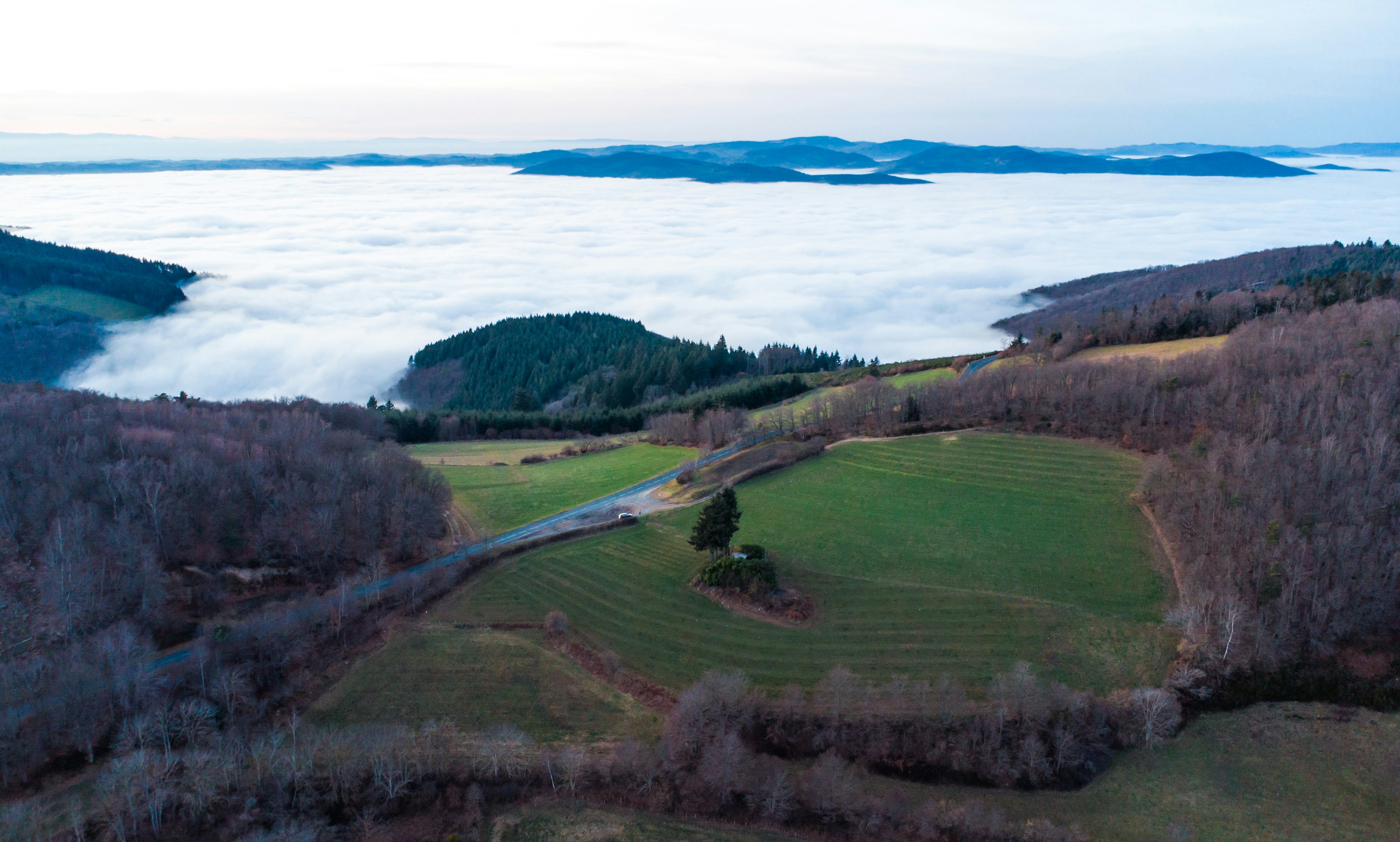 Rolling hills covered in fog with distant islands