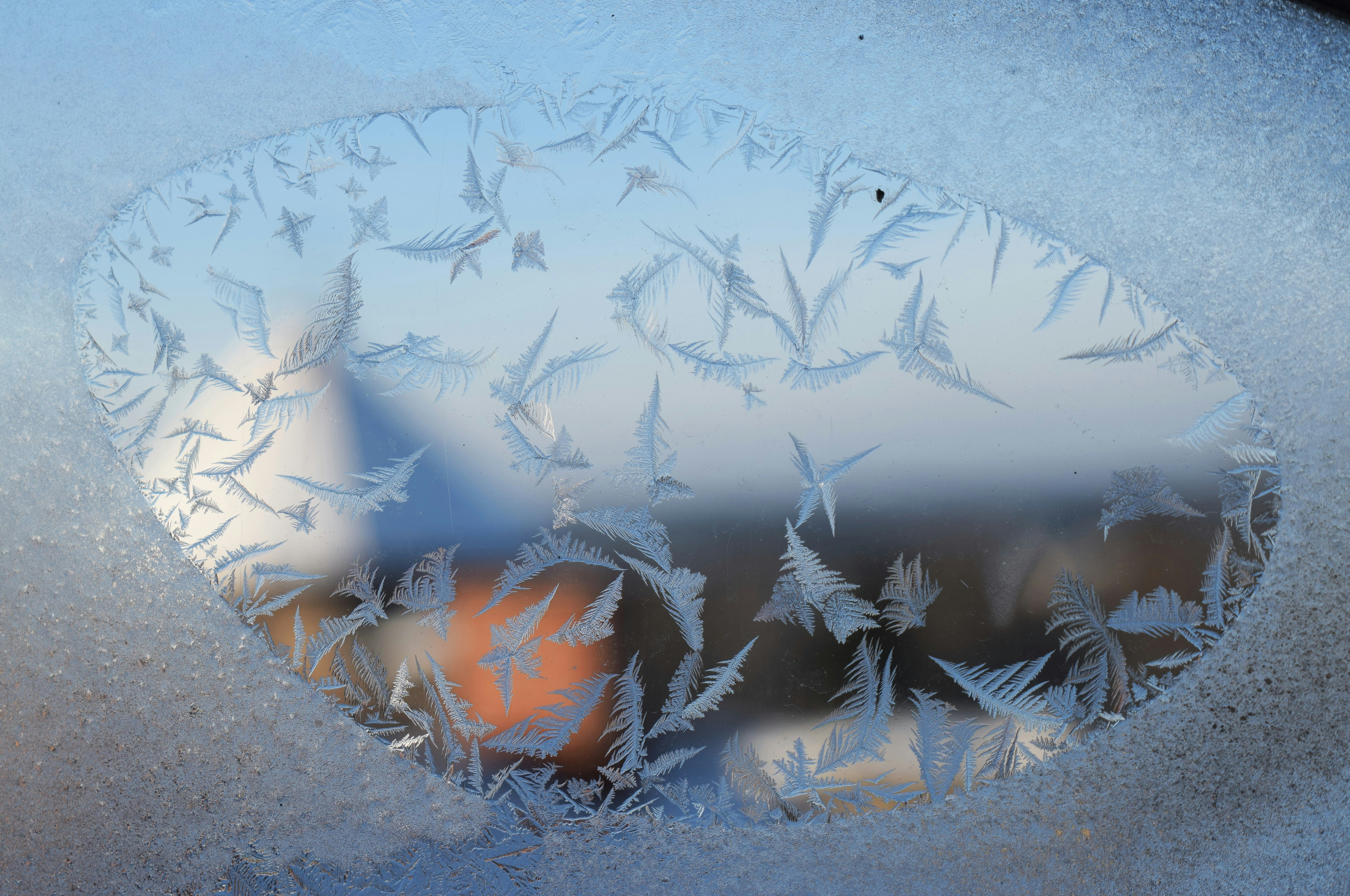 Frost patterns on a window with blurred background