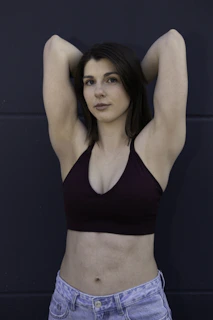 Young woman in sports bra and jeans